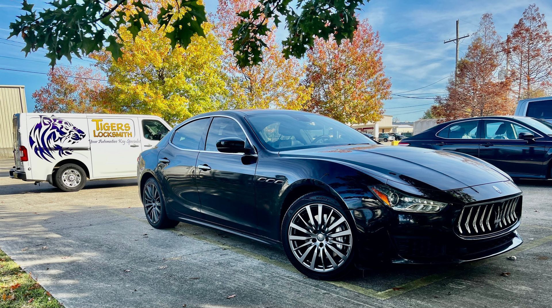 Locksmith service van and a black Maserati Ghibli