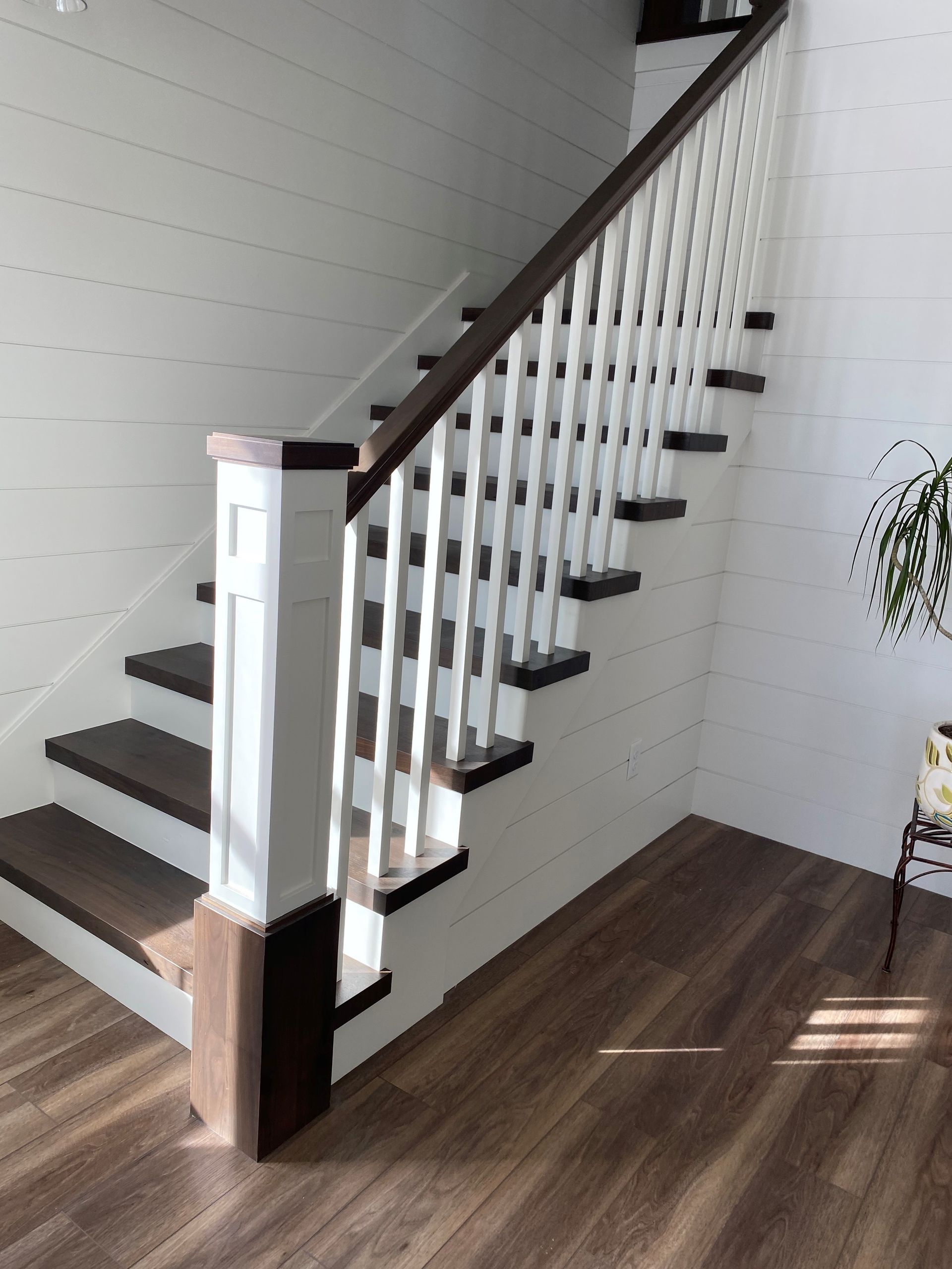 A staircase with wooden steps and a white railing