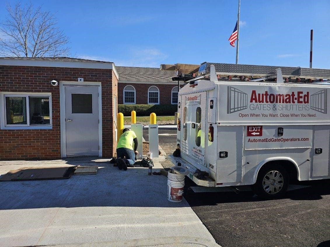 A white truck with the word automated on the side is parked in front of a brick building