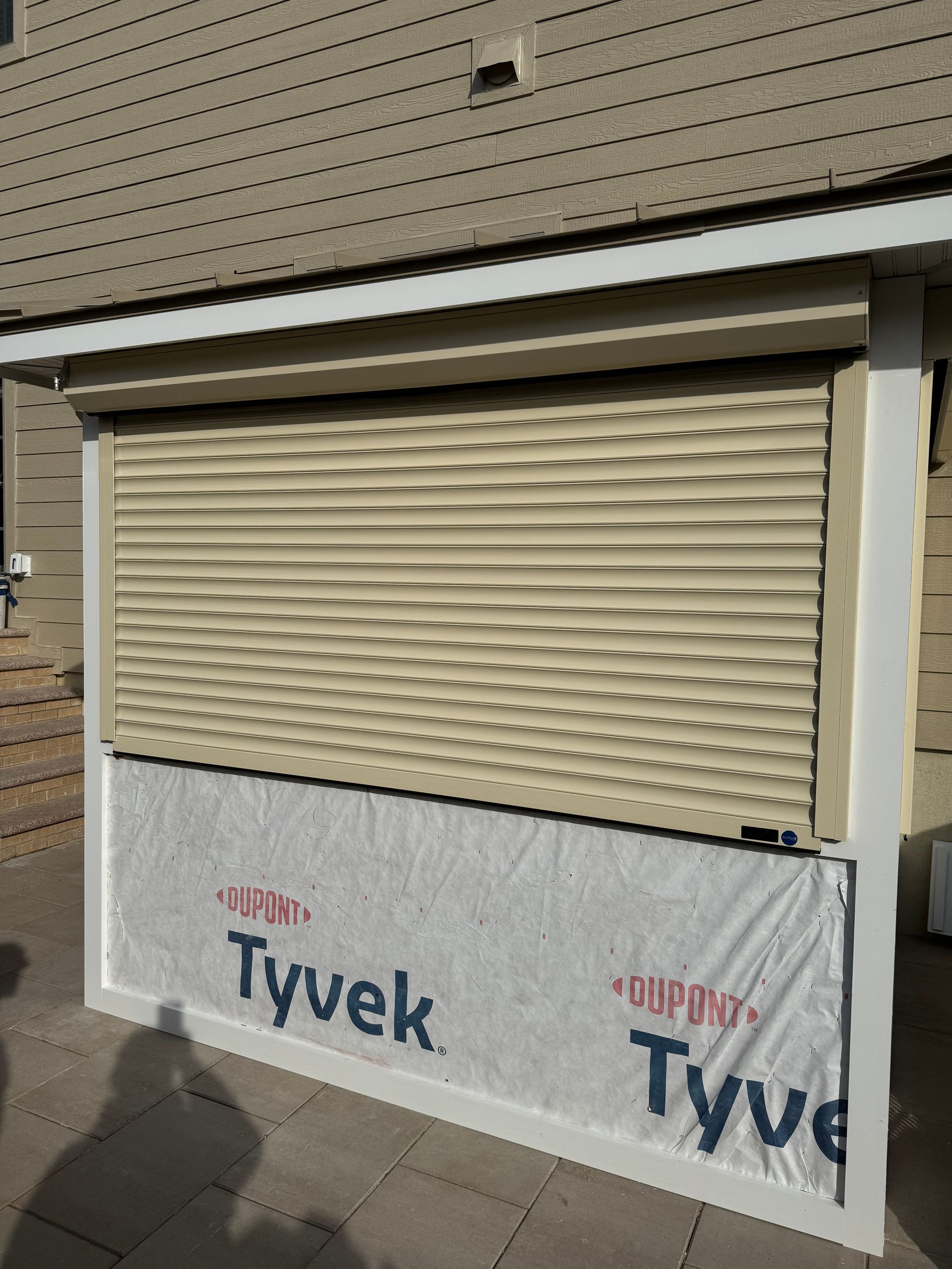 A building with a shutter on it that says tyvek on it