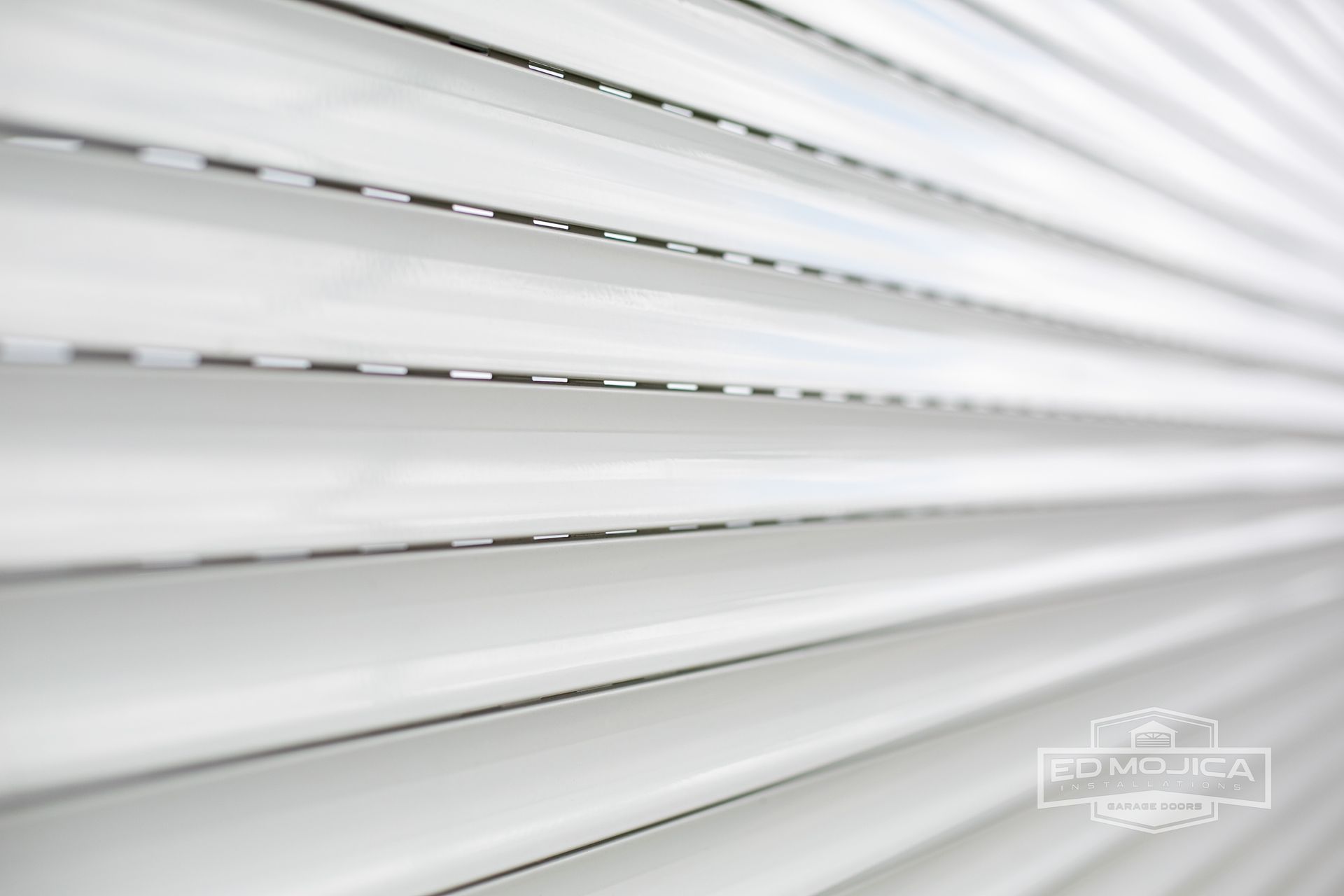 A close up of a white roller shutter on a window