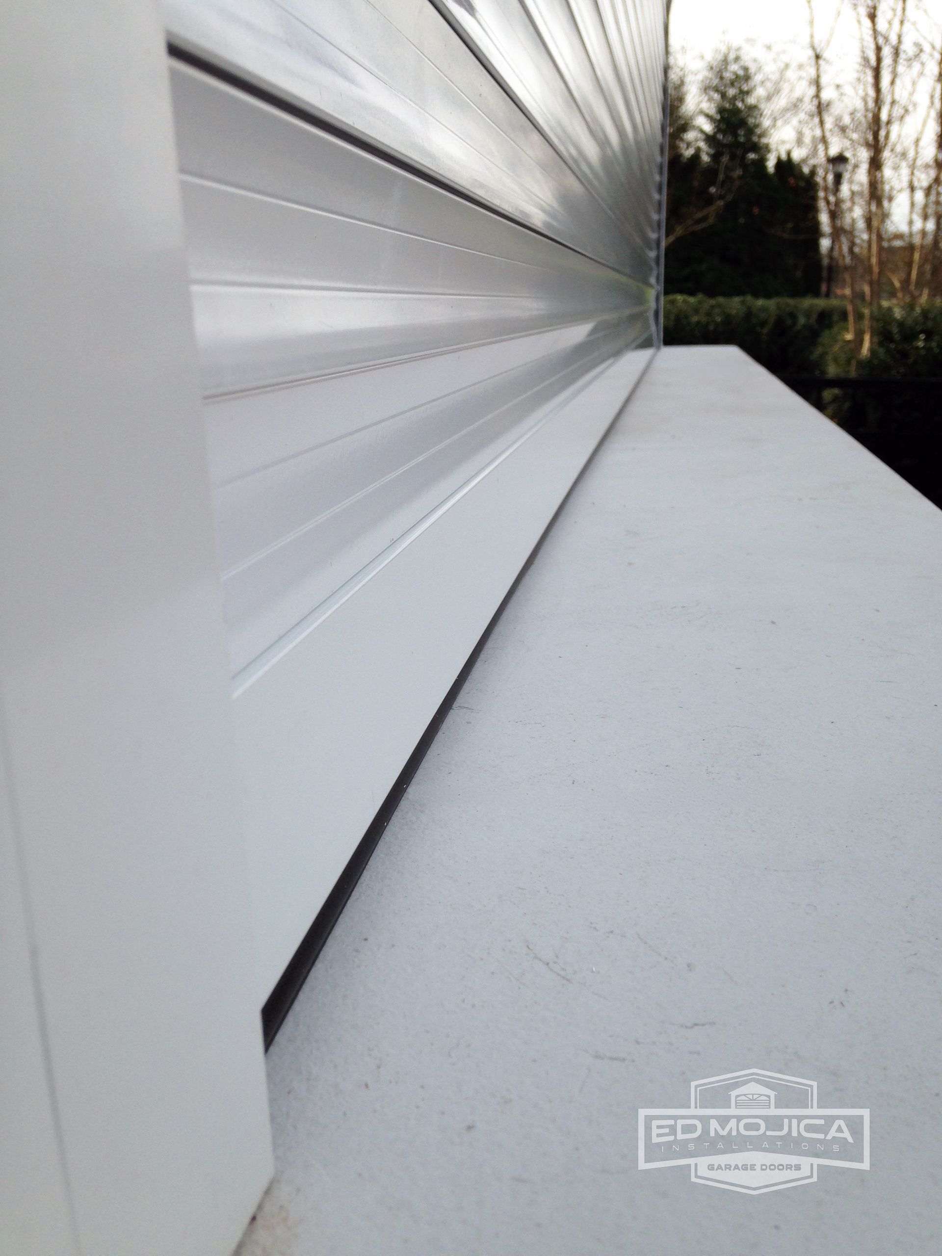 A close up of a white shutter on a window
