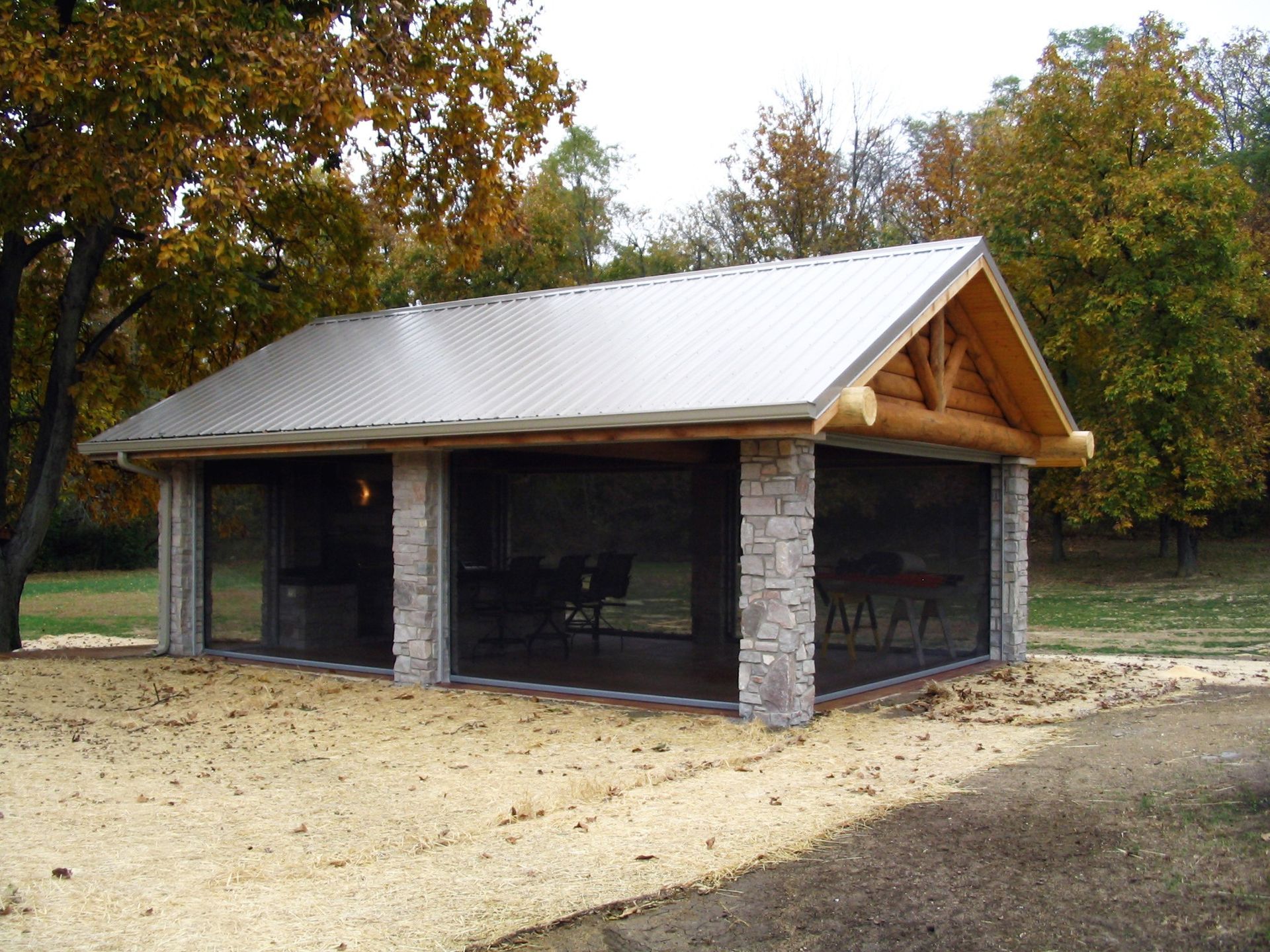 A large screened in area with a metal roof
