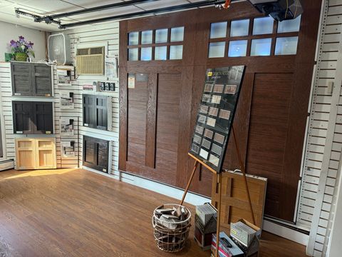There are many different types of garage doors on display in this room.