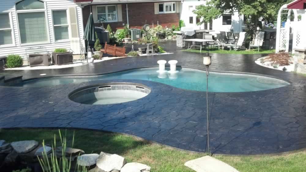 A large swimming pool in the backyard of a house