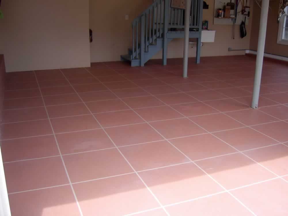 A tiled floor in a room with stairs in the background