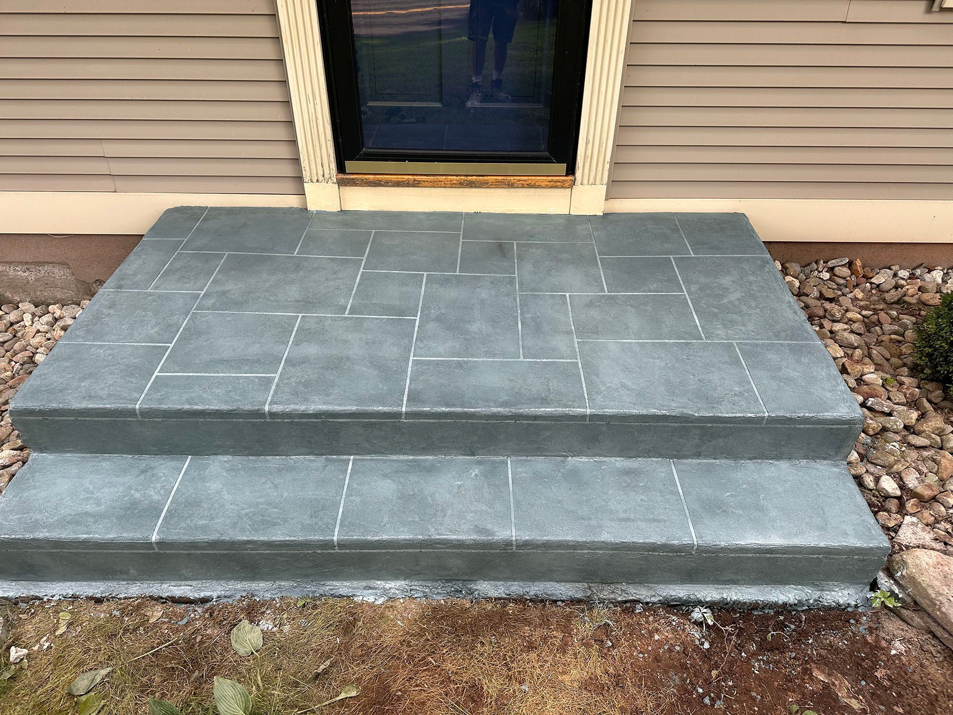 A set of steps leading up to a doorway of a house.
