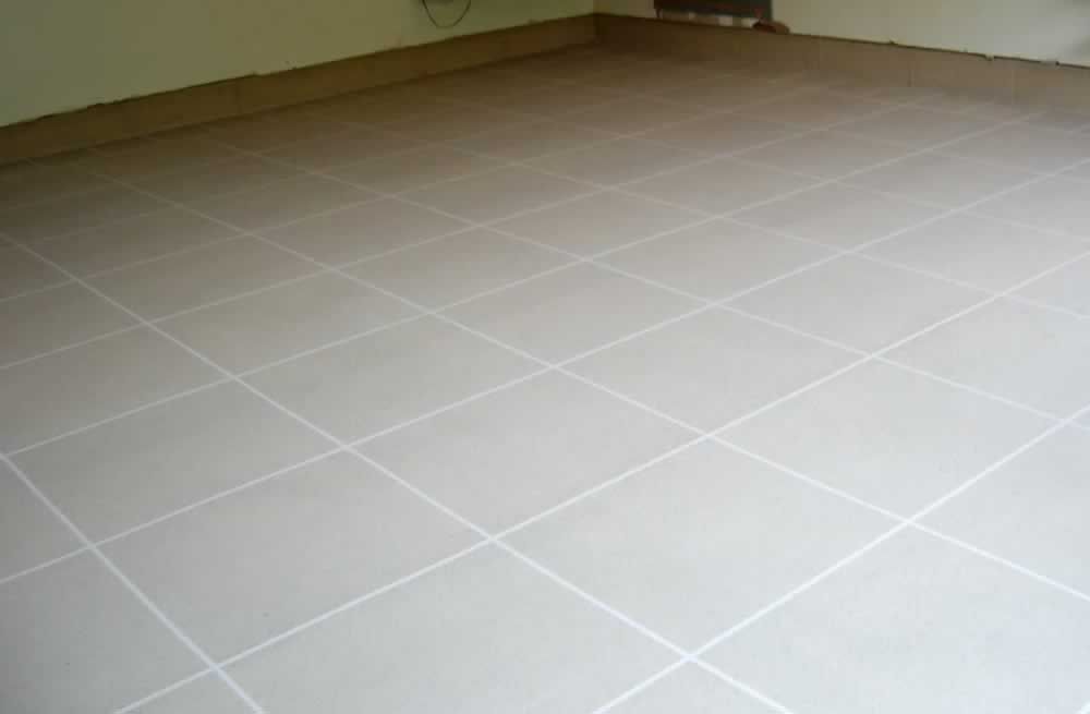 A room with a tiled floor and a white wall.