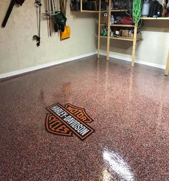 A harley davidson logo is on the floor of a garage