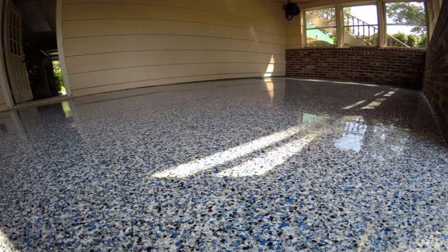 A garage with a blue and white epoxy floor.