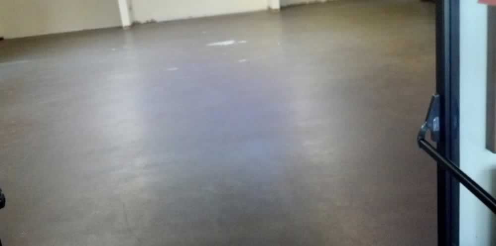 A door with a handle on it is open in an empty room.