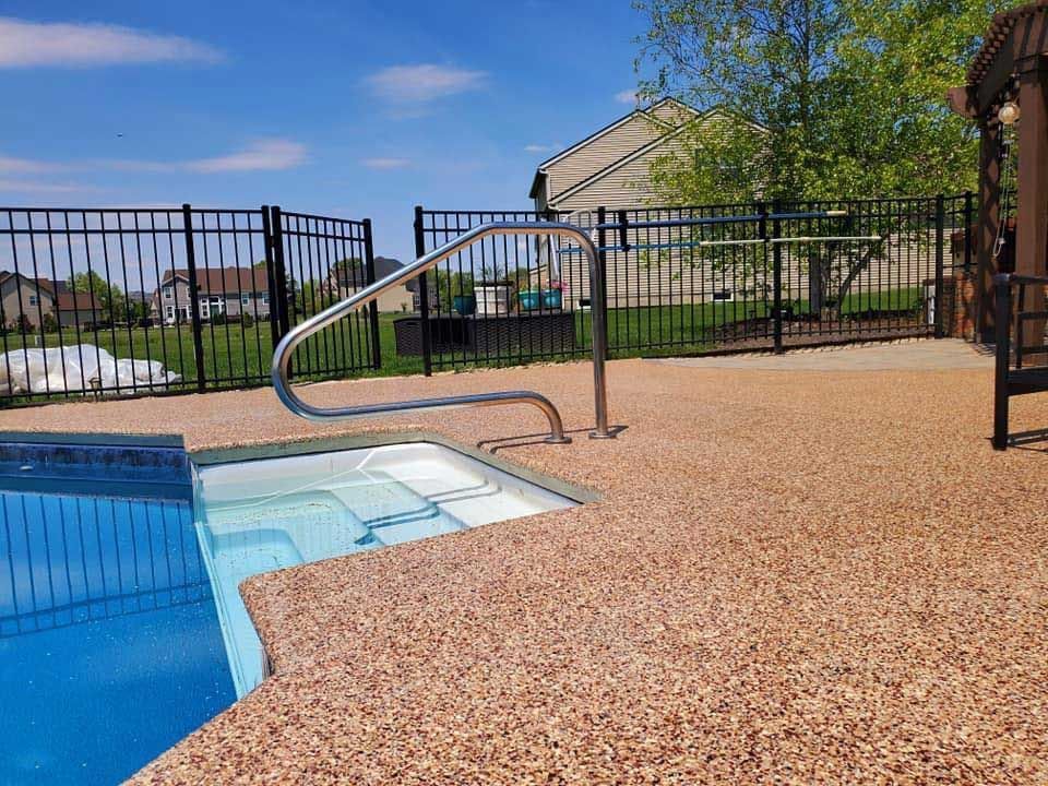 A swimming pool with a metal fence surrounding it