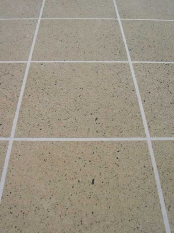 A close up of a tiled floor with white lines