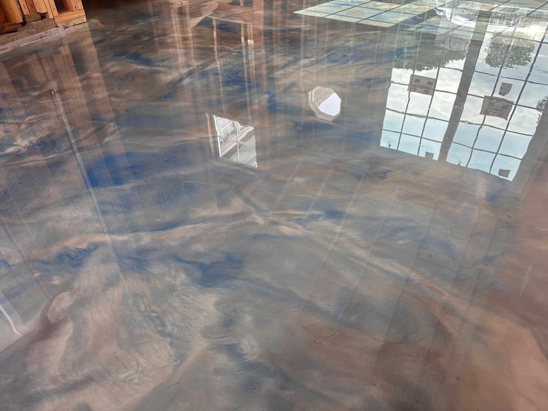 A close up of a shiny metallic floor in a room.