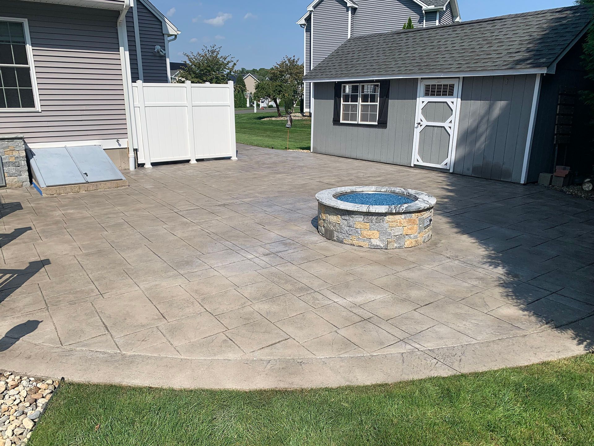 There is a fire pit in the middle of the patio.