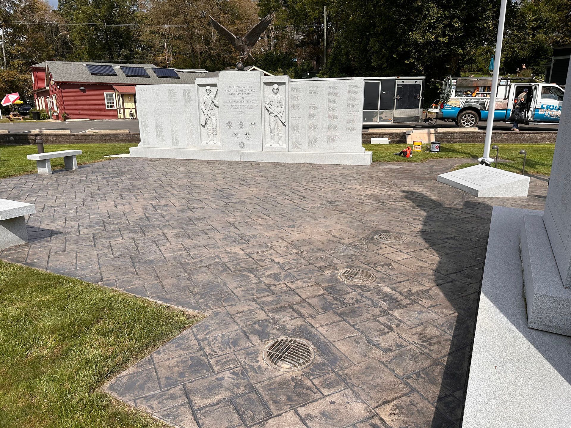 A memorial in a park with a list of names on it