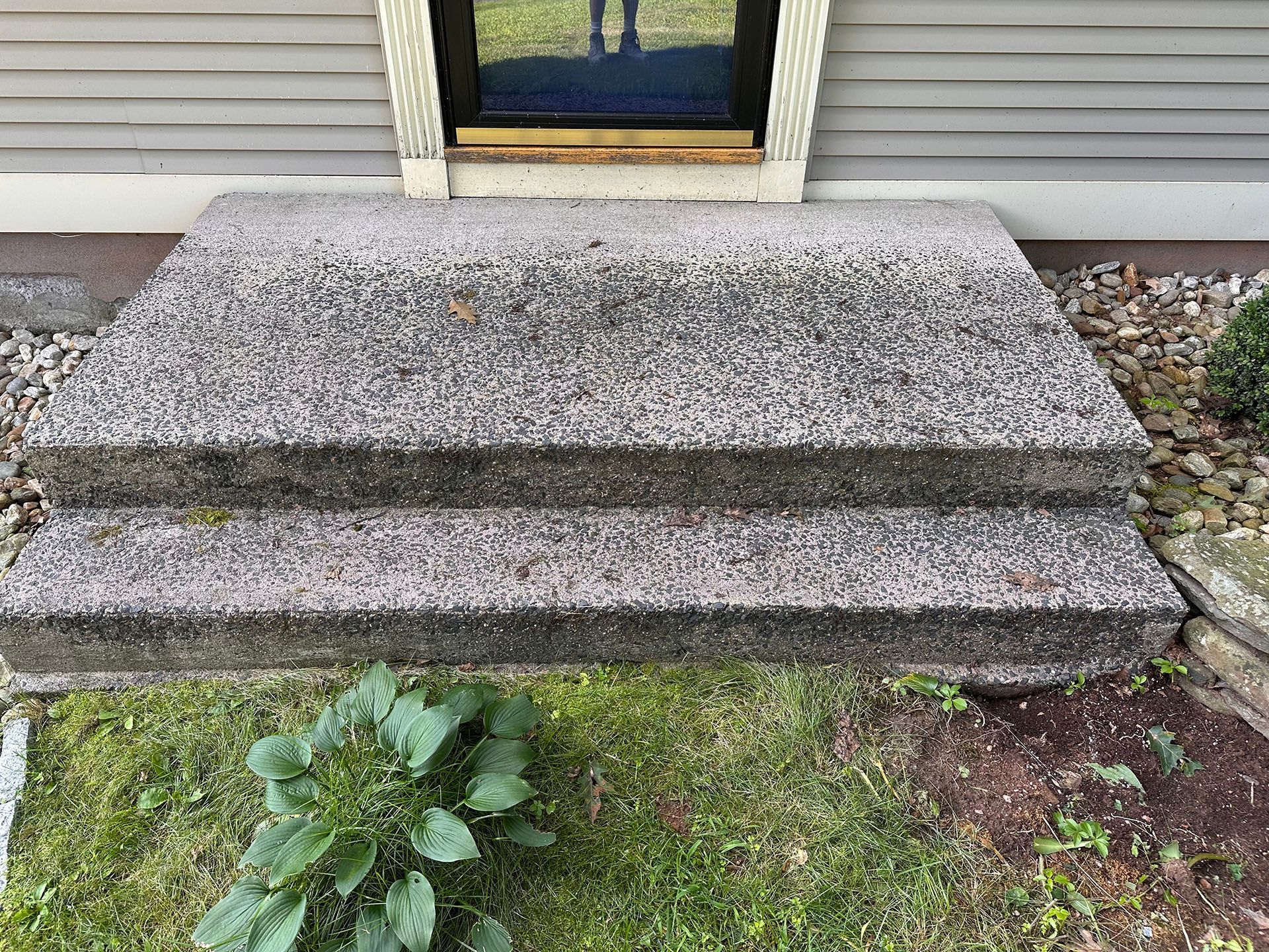 A set of concrete steps leading up to a house.