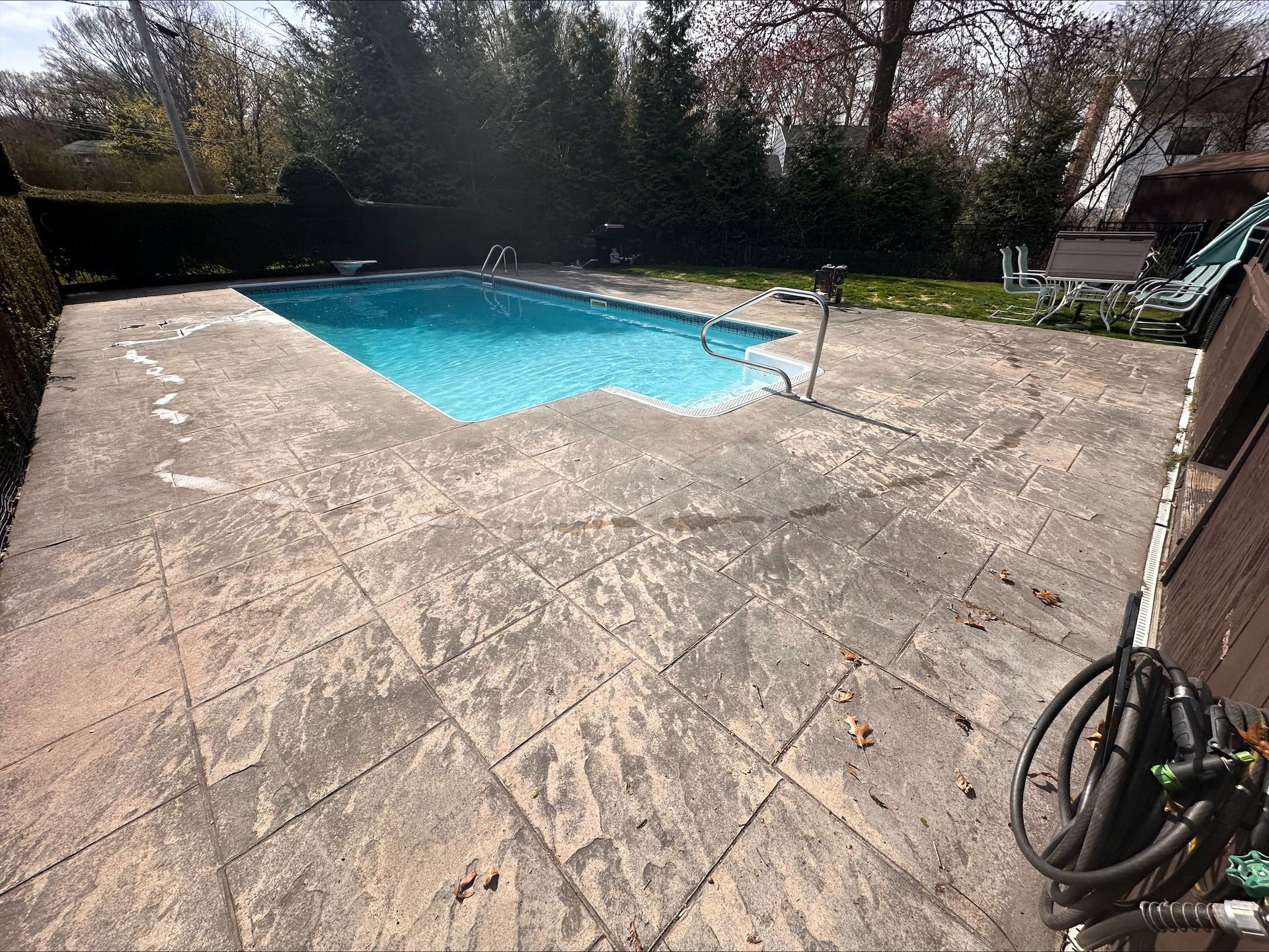 There is a large swimming pool in the backyard.