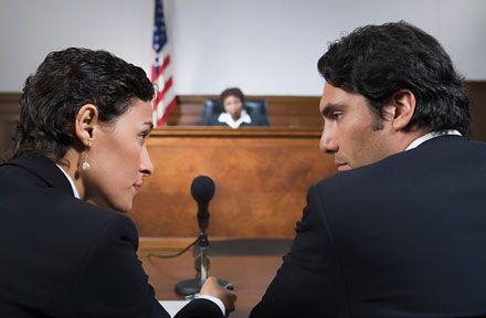 A female lawyer confidently talking to her client in court