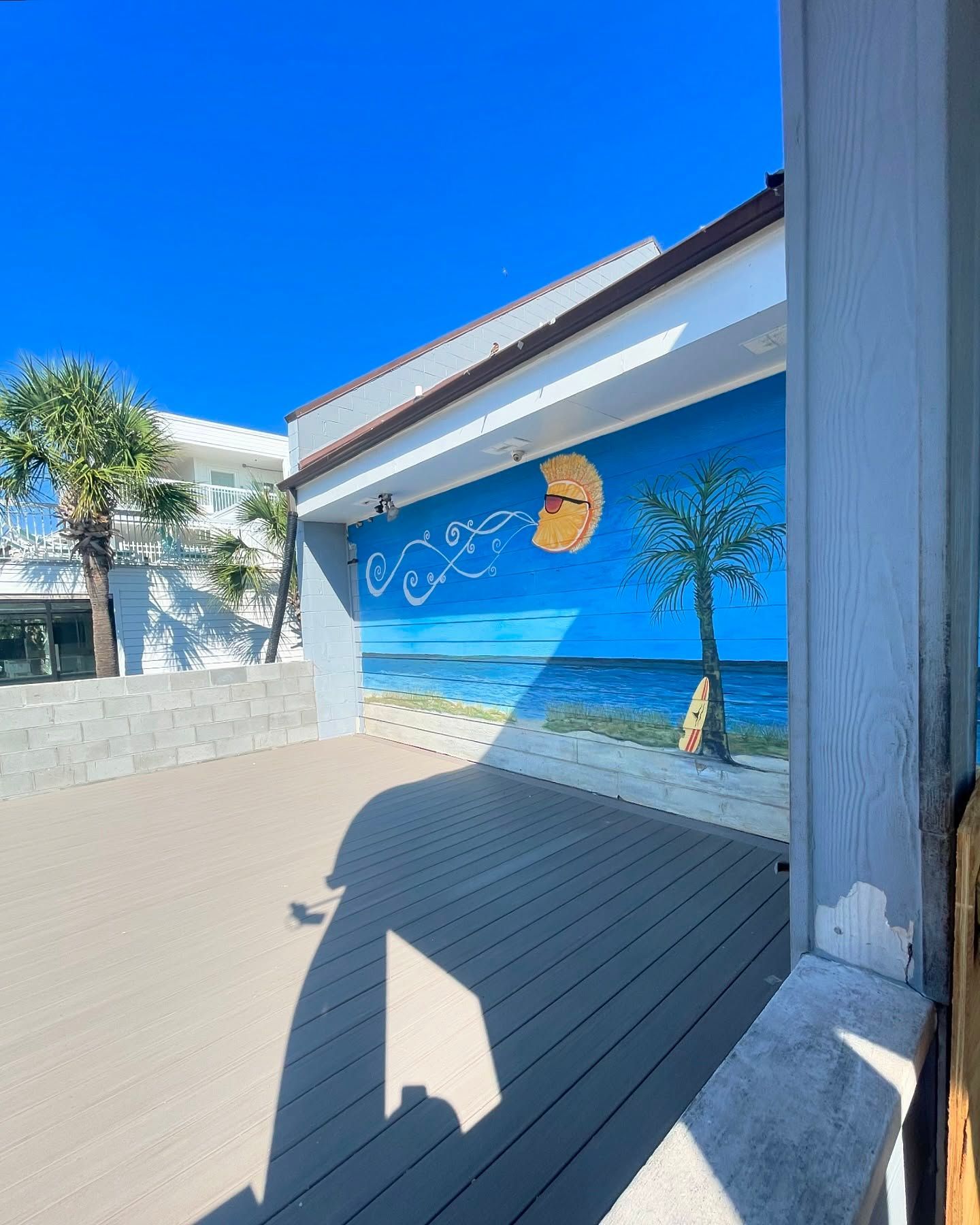 A painting of a palm tree on the side of a building