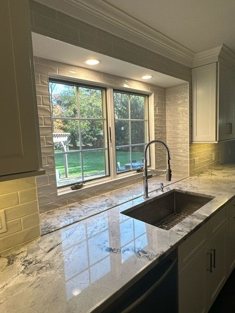 A kitchen with a sink and a window.