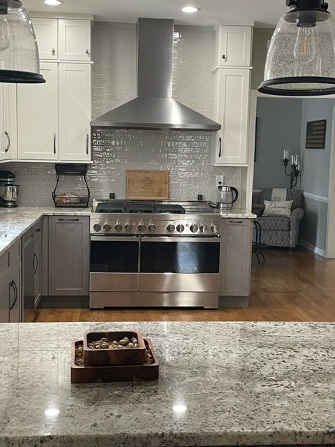 A kitchen with stainless steel appliances and white cabinets.