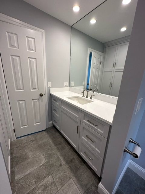 A bathroom with two sinks and a large mirror