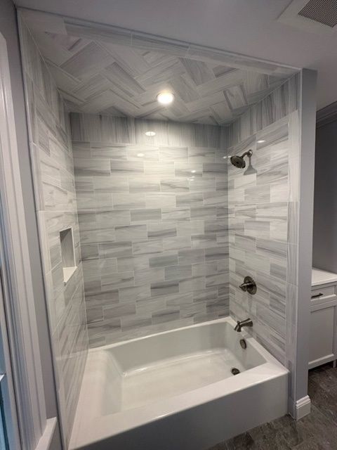 A bathroom with a bathtub and a shower.