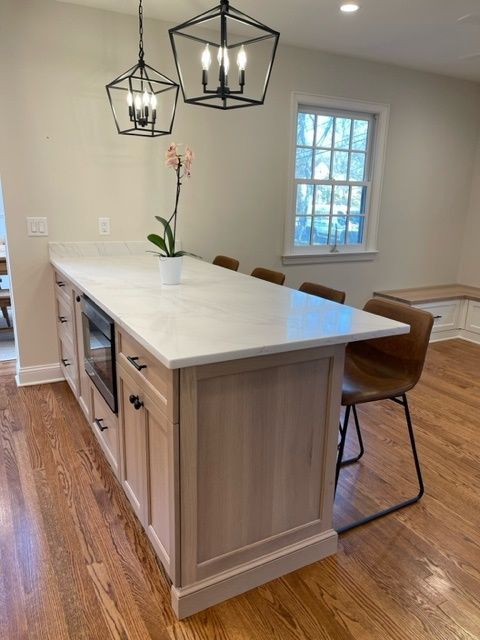 A kitchen with a large island and a window