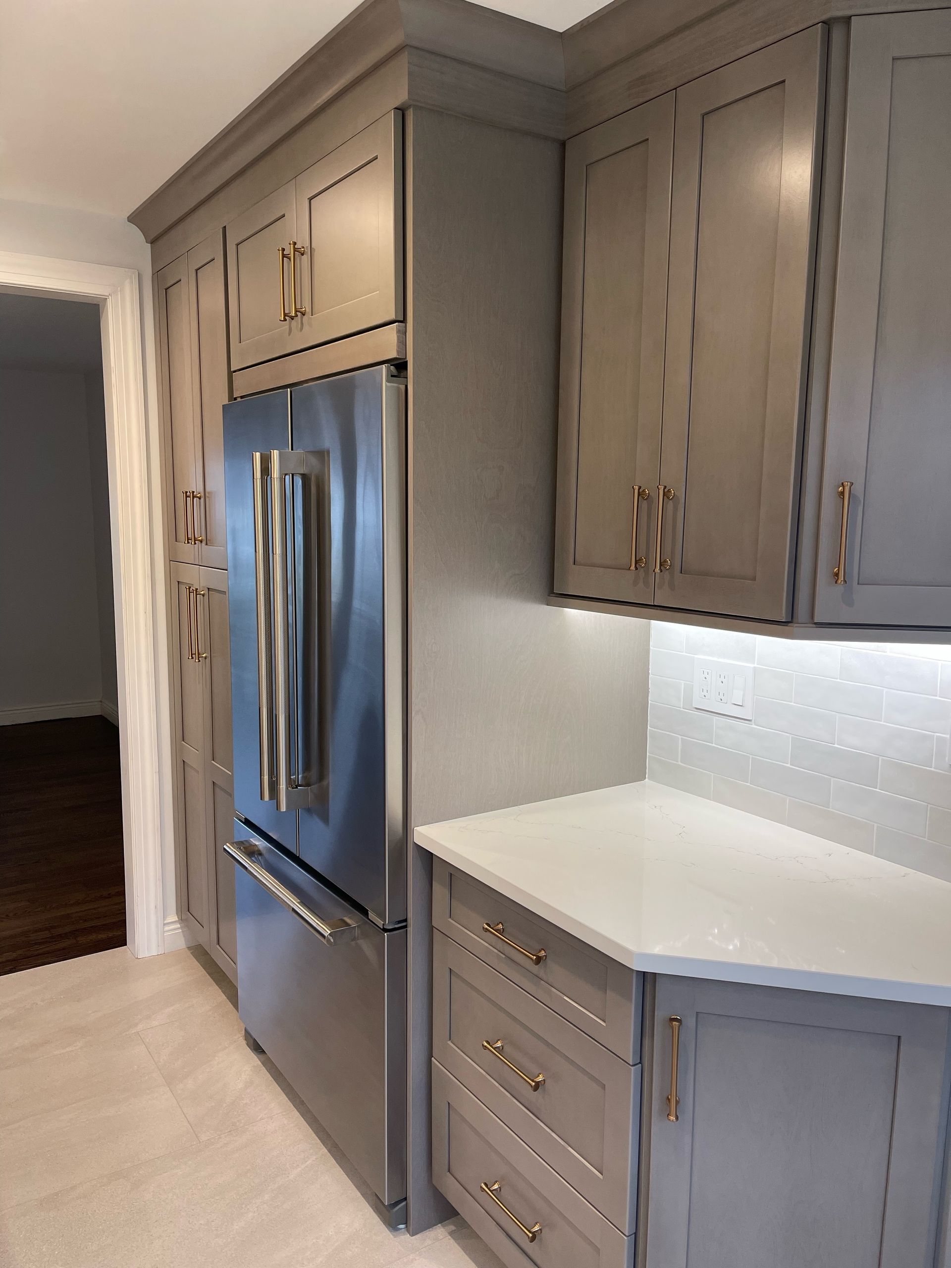 A kitchen with gray cabinets and a blue refrigerator