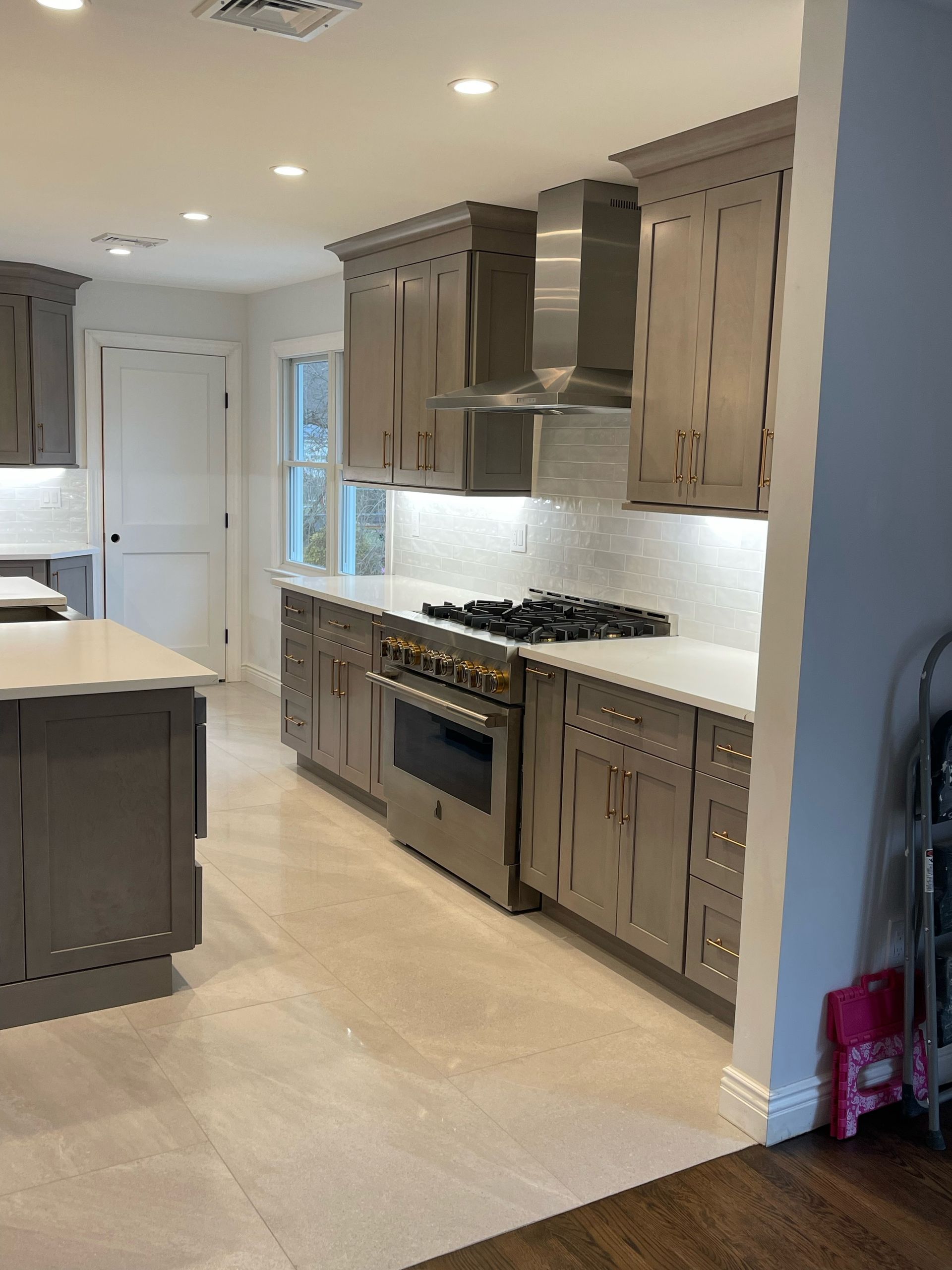 A kitchen with stainless steel appliances and wooden cabinets.