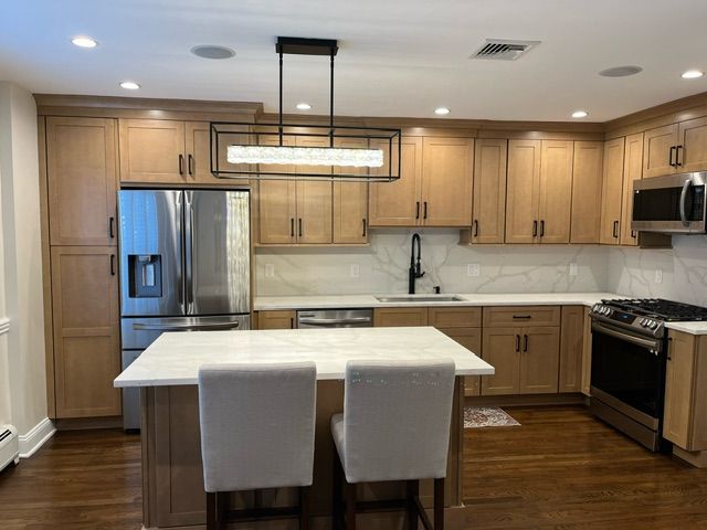 white countertop kitchen island with two white chairs