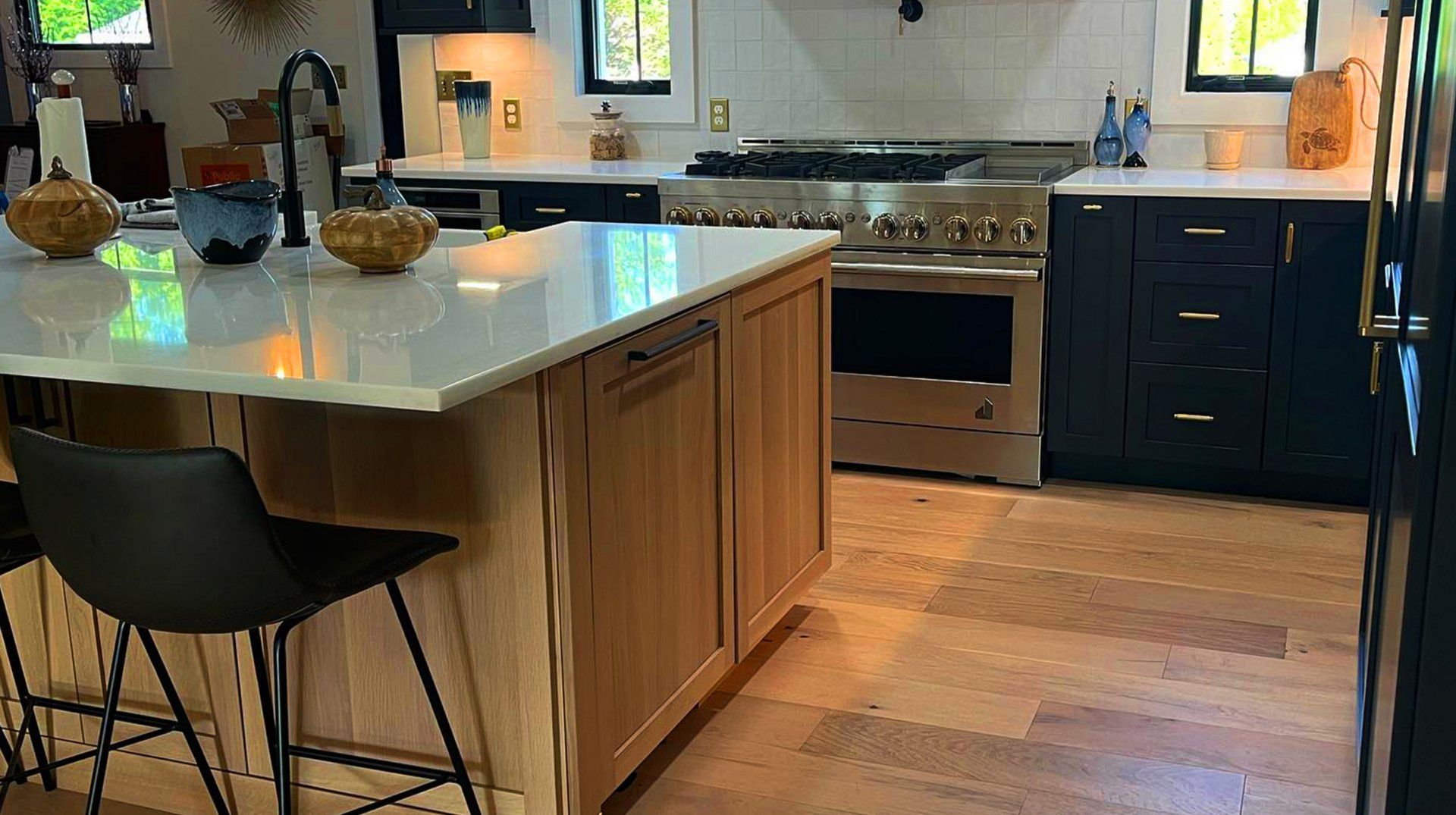 A kitchen with stainless steel appliances , wooden cabinets , and a large island.