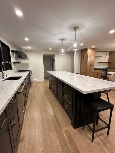 There is a large island in the middle of the kitchen.