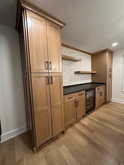A kitchen with wooden cabinets and a refrigerator