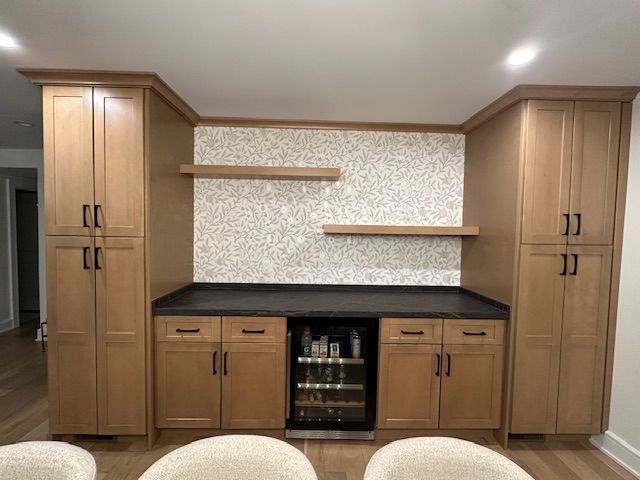 A kitchen with lots of cabinets and a refrigerator