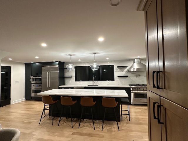 A kitchen with a large island and stools