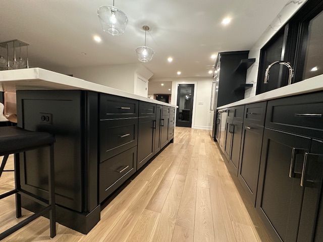 A kitchen with a white counter tops