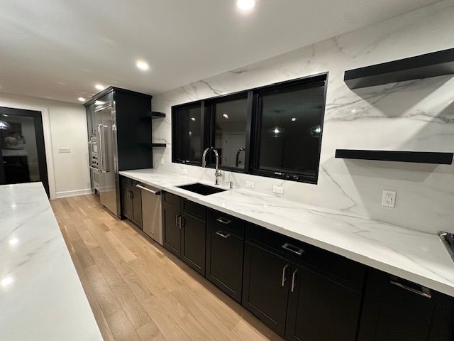 A kitchen with a white counter tops