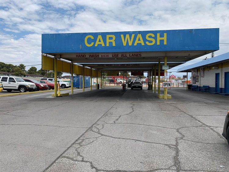 A car wash with cars parked in front of it