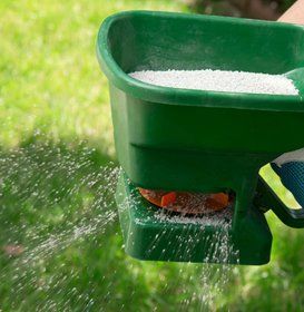 Fertilizer being showered at a lawn