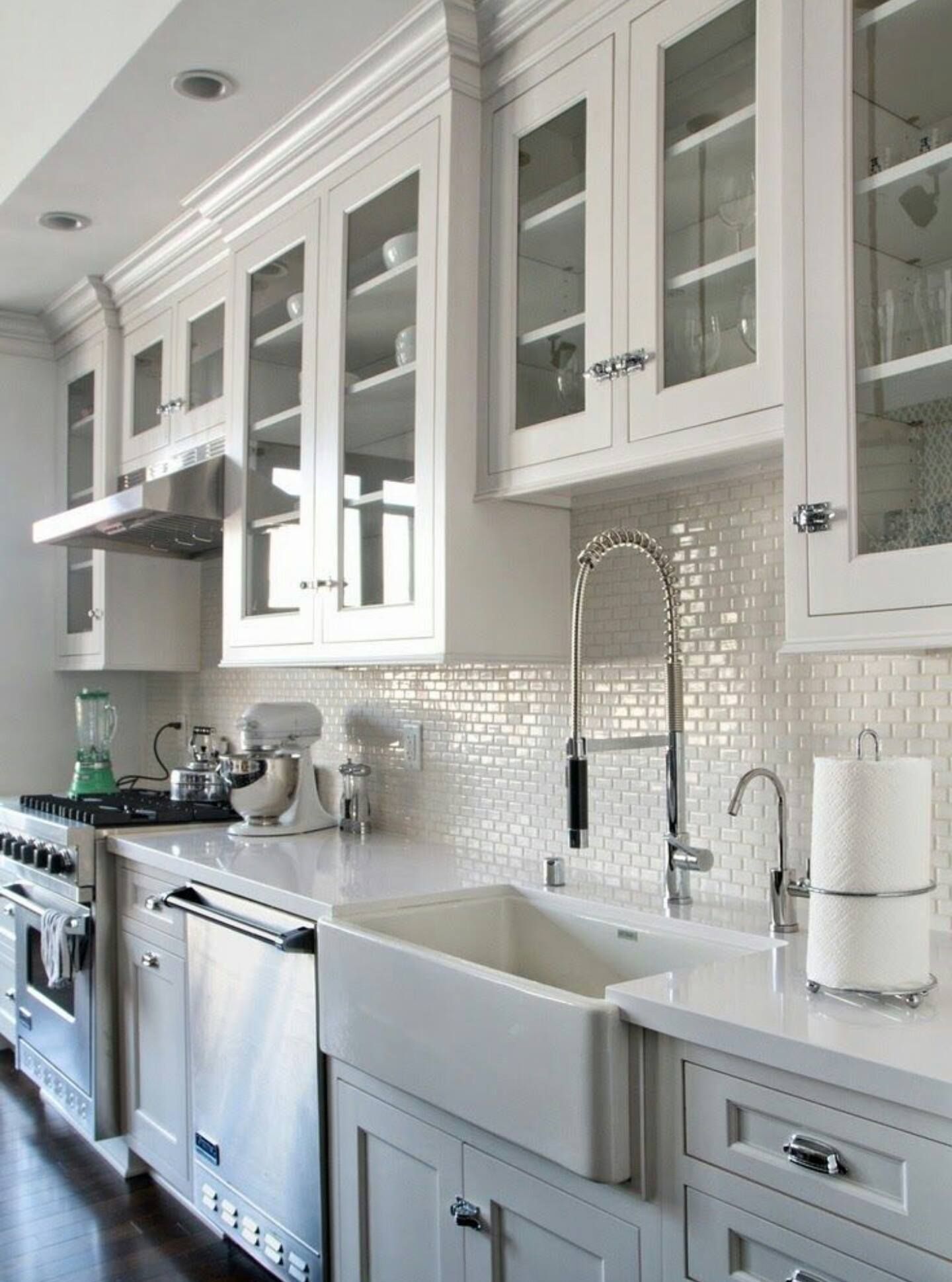 a kitchen with white cabinets and a white sink
