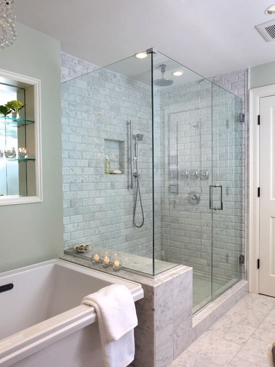 a bathroom with a bathtub and a walk in shower