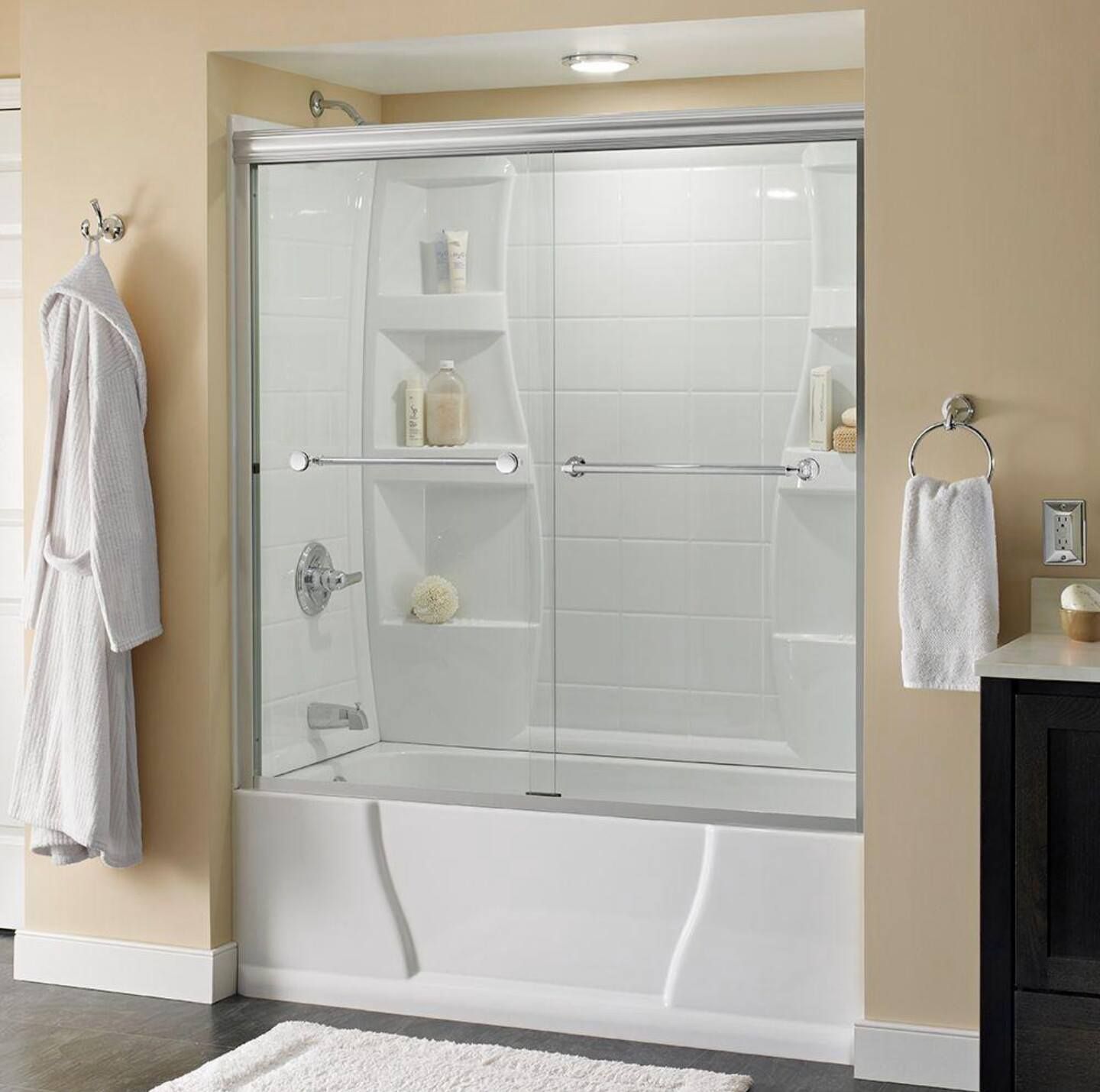 a bathroom with a bathtub and a sliding glass shower door