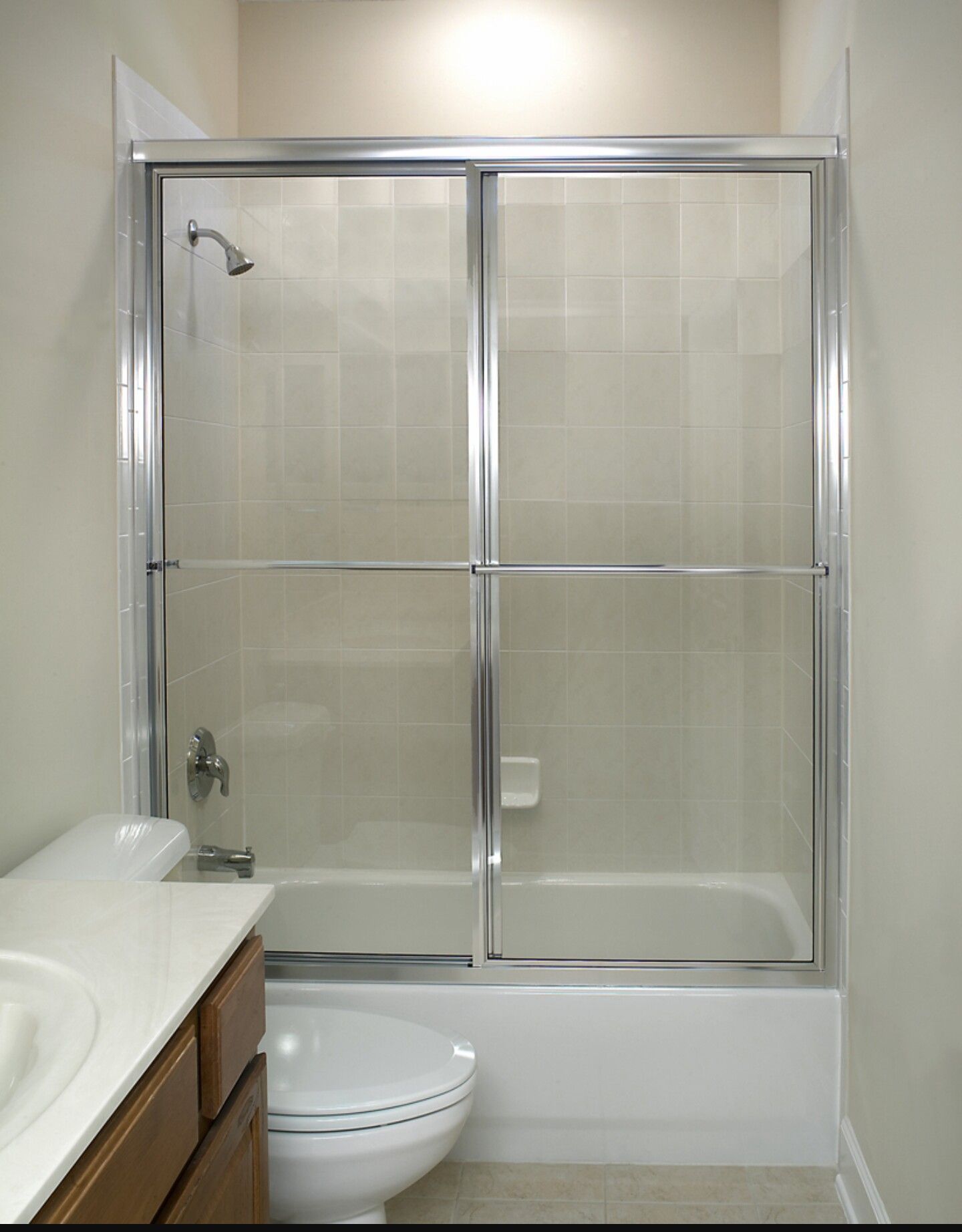 a bathroom with a sliding glass shower door