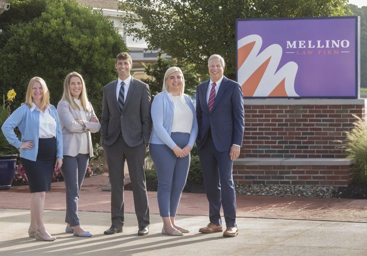 A group of people standing in front of a melling sign