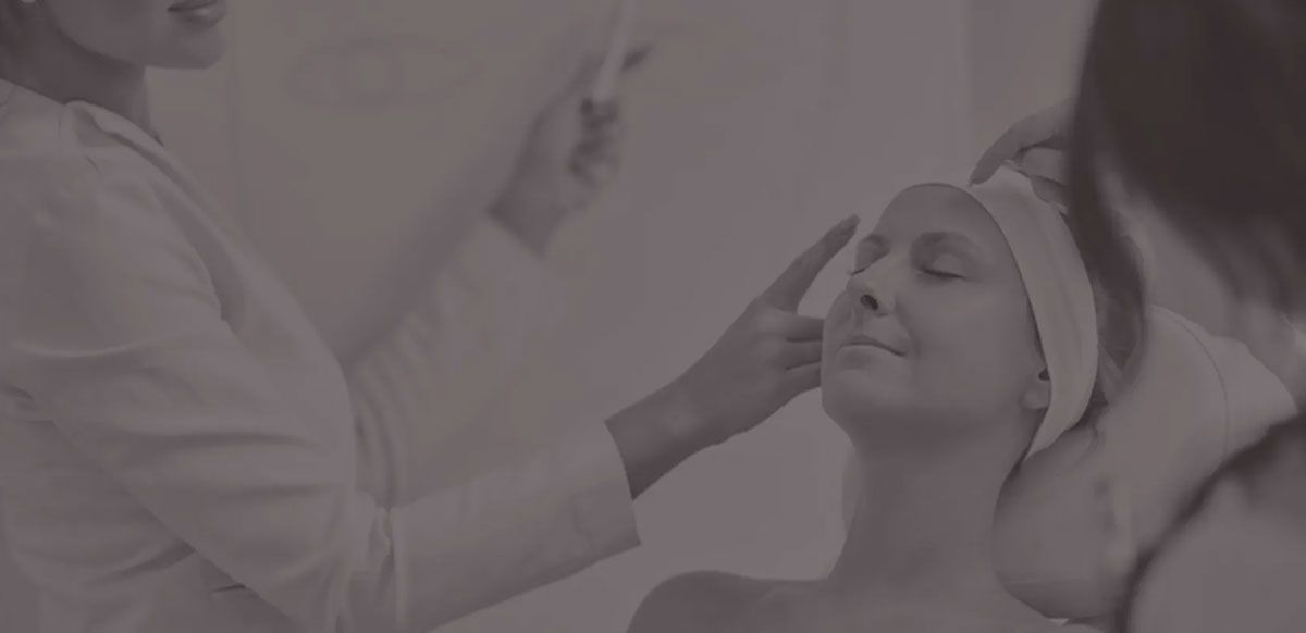Aesthetic treatment being applied to a woman’s face in a spa setting