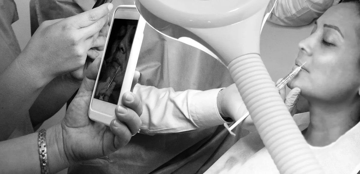Medical staff adjusting a breathing tube for a patient in a clinical setting