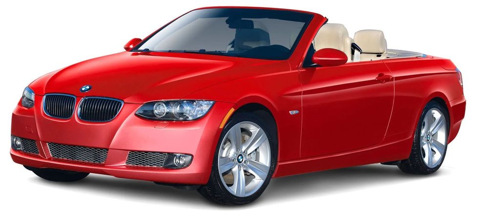 Red BMW convertible with beige interior, angled front view on white background