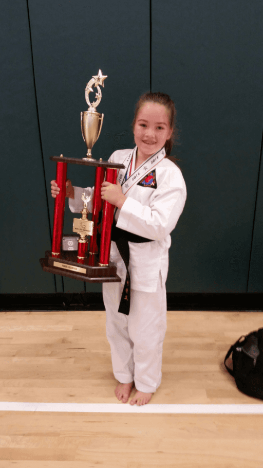 Young girl holding her trophy